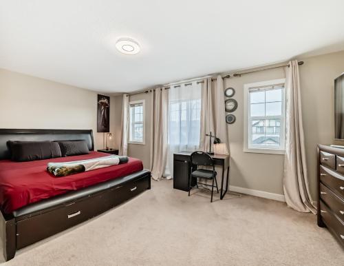 a bedroom with a bed and a desk at Rome, Sweet Home in Calgary