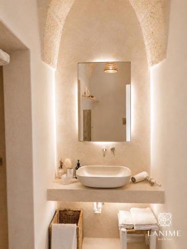 a bathroom with a sink and a mirror at Lanime - Bed in Spa in Sogliano Cavour