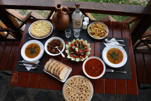 a table with various dishes of food on it at Qaldea Resort in Ushguli