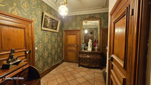 a bathroom with a vanity and a mirror on the wall at Chambre Henri II in Fleuriel