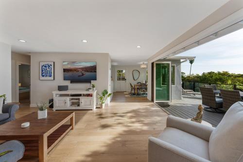 a living room with a couch and a table at Summerland SeaSpa Retreat | The Chosen Collection in Summerland