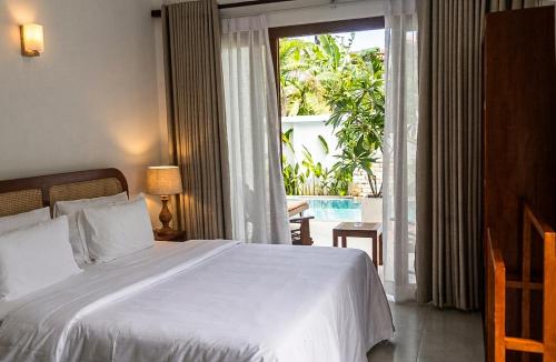 a bedroom with a bed and a large window at Still Reef in Matara
