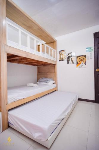 a bedroom with two bunk beds in a room at Sam's Residence in Marilao