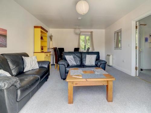 a living room with a couch and a coffee table at Thistle Cottage in Ryde