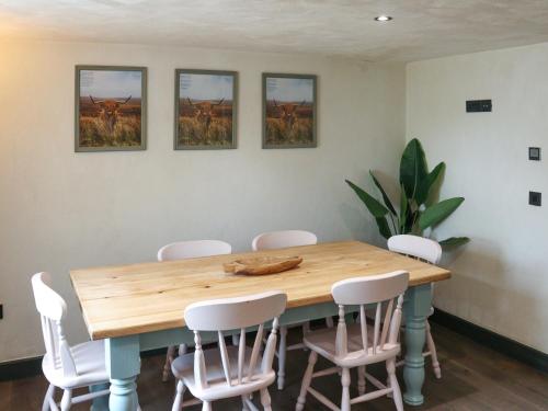 a dining room with a wooden table and chairs at Brynawel in Maenclochog