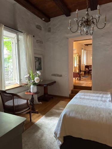 a bedroom with a bed and a table with flowers on it at Old town gem in Tallinn