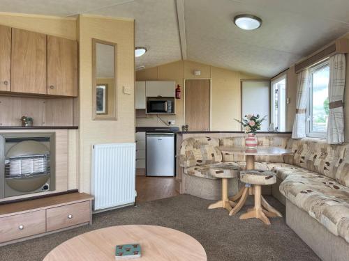 a large living room with a couch and a table at Valley View - Uk52130 in Oakmere