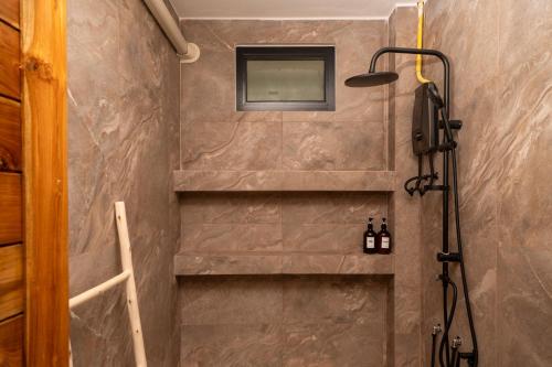 a bathroom with a shower with a mirror on the wall at Blue Sky Seaview in Haad Yao