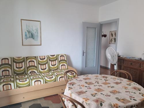 a living room with a table and a couch and a table and chair at Casa MAX in Onno