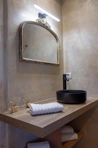 a bathroom with a sink and a mirror at Villa Les Bergeries De Calvi in Calvi