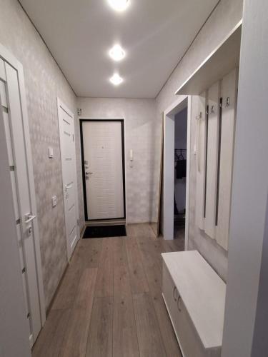 a hallway with a large door in a room at Ткачёва in Pavlodar