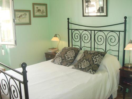 a bed with two pillows on it in a bedroom at Bela Vista in Lourinhã