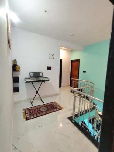 a room with a staircase and a table in it at Netra Kunj in Paliem