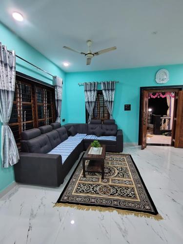 a living room with a couch and a table at Netra Kunj in Paliem