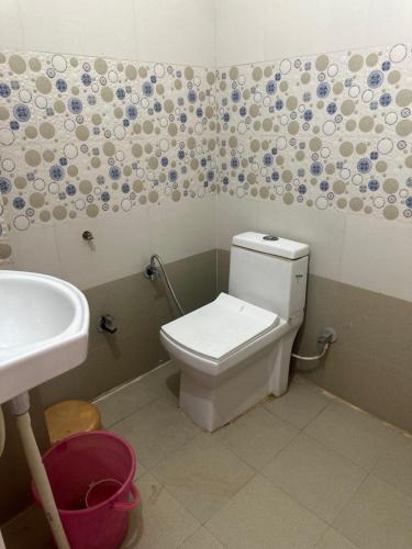 a bathroom with a toilet and a sink at KK Hotel in Jaipur
