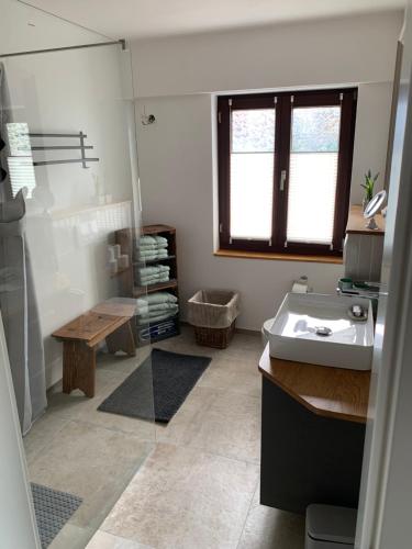 a bathroom with a sink and a mirror at Fewo Fernblick in Much