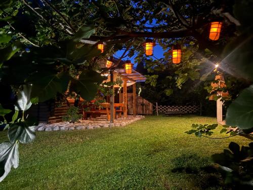 a backyard with a gazebo at night at Edi Cottage in Bovec