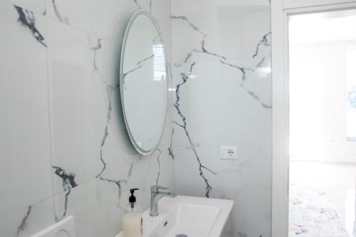 a bathroom with a sink and a mirror on the wall at Miri House in Domje