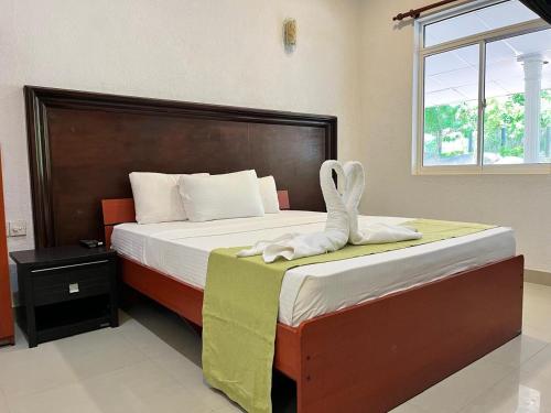 a bedroom with a bed with a bunny foot on it at The Rock Yala in Yala