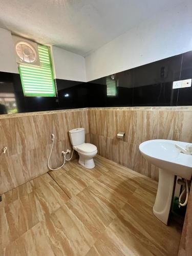 a bathroom with a toilet and a sink at The Rock Yala in Yala