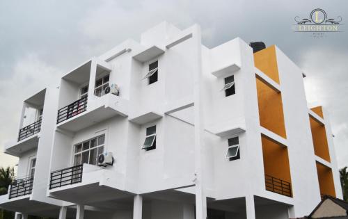 a white building with an orange at Leighton Resort in Negombo
