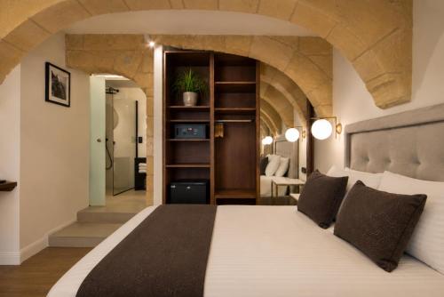 a bedroom with a large bed in a room at 23 Boutique Hotel in Il-Furjana