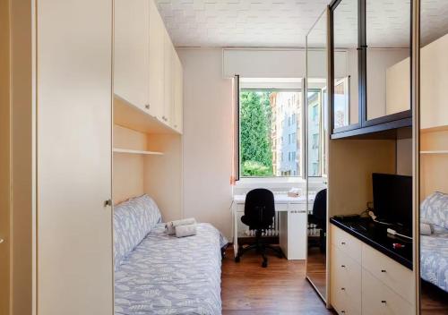 a bedroom with a bed and a desk and a window at Nadilla House Castellanza Humanitas Liuc in Castellanza