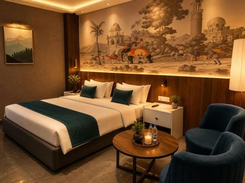 a hotel room with a bed and two chairs at Hotel Cassa Inn in Bathinda