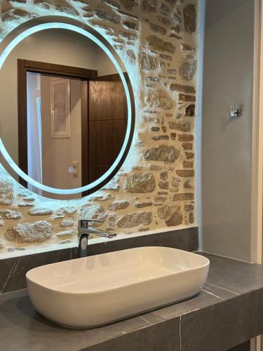 a bathroom with a white sink and a mirror at Effies Apartments in Karlovasi