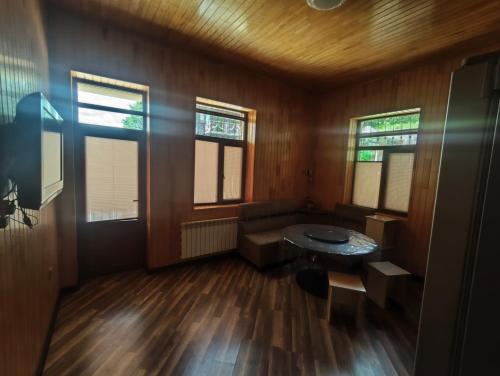 a living room with a couch and a table at Family Villa with Pool in Əski İqrığ