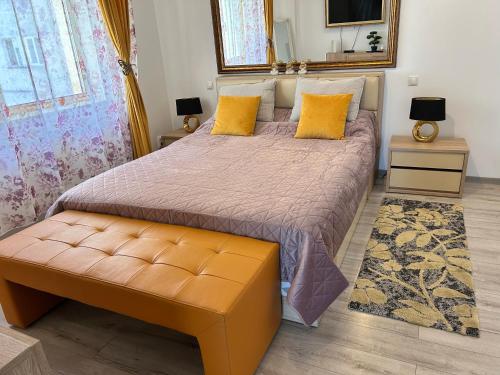 a bedroom with a large bed with yellow pillows at Silver De Lux in Bacău