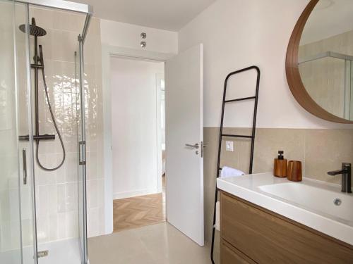 a bathroom with a shower and a sink and a mirror at Praia - Boa Onda in Cee