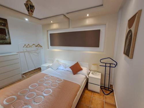 a bedroom with a bed and a flat screen tv at Dar YLA in Tétouan