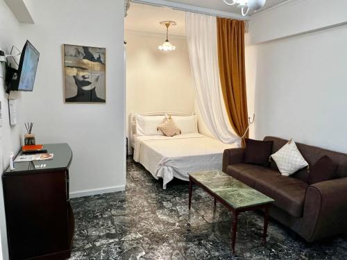 a living room with a bed and a couch at Boutique Sea & Garden in Vari