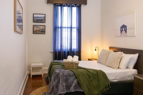 a bedroom with a bed and a window at The Beaconsfield Hotel in Fremantle