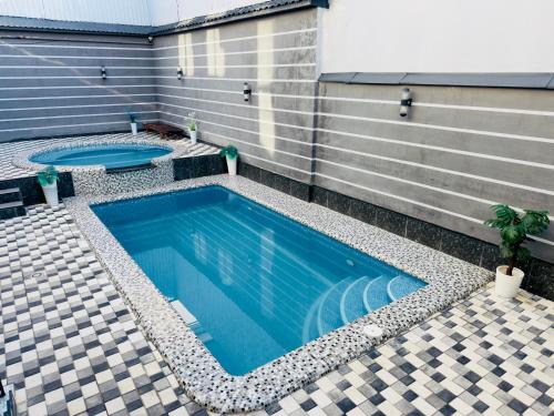 a swimming pool in the side of a building at Art Tashkent Hotel in Tashkent