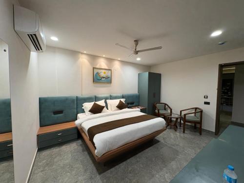 a bedroom with a bed and a table and chairs at Hotel Bella Vento Luxury Stay Near CGC Landran Mohali Chandigarh in Kharar