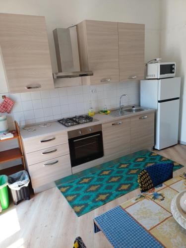a kitchen with a stove and a refrigerator at Villa Alma in Bari