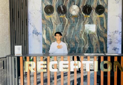 a picture of a man on a wall with a sign at Art Tashkent Hotel in Tashkent
