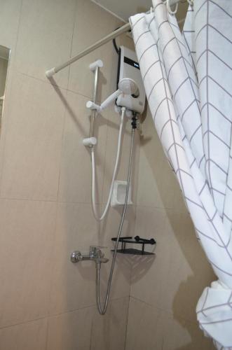 a shower in a bathroom with a shower curtain at Condo Inspiria Beside Abreeza Mall in Davao City