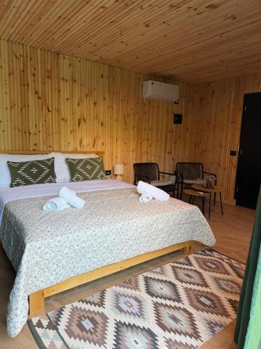 a bedroom with a bed with two towels on it at Villa Ujëvara e vogël in Theth