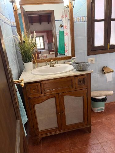 a bathroom with a sink and a mirror at Finca Nim 2 in Mogán