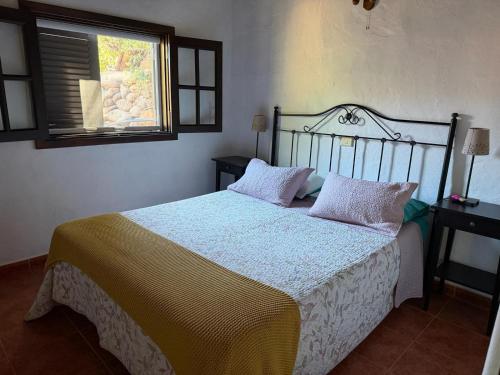 a bedroom with a bed and a window at Finca Nim 2 in Mogán