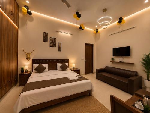 a bedroom with a bed and a couch at Hotel Oxygen Stay in Noida