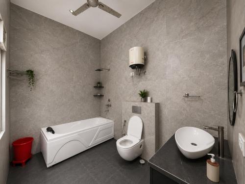a bathroom with a white toilet and a sink at Hotel Oxygen Stay in Noida