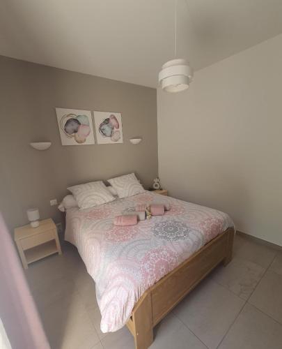 a bedroom with a bed with two dolls on it at LA MASTRONA in Saumane-de-Vaucluse