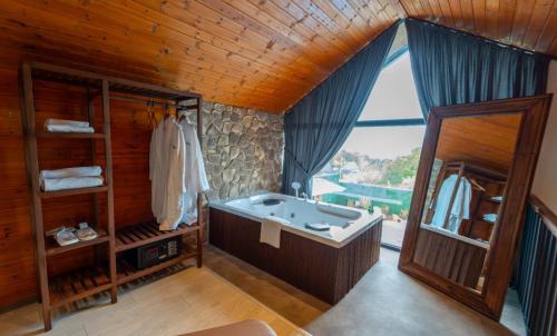a large bathroom with a tub and a large window at JUNGLOW Sapanca in Sapanca
