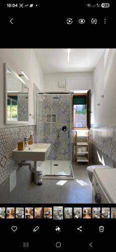 a bathroom with a shower and a sink and a tub at Casa Vacanze Alba in Pianillo