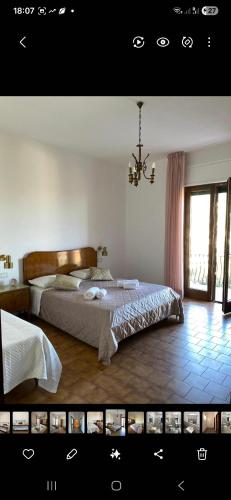a bedroom with a large bed and a window at Casa Vacanze Alba in Pianillo