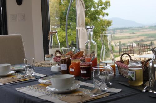 a table with a blue table cloth with food on it at Au Fil des Cévennes in Saint-Jean-de-Maruéjols-et-Avéjan